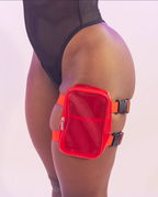 Transparent thigh bag with a red pocket worn by a person on a light gray background