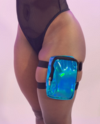 Holographic thigh bag worn by a person on a light pink background